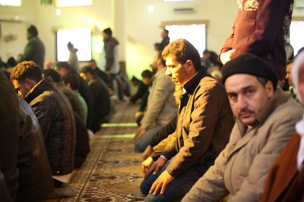 Syrian refugees pray at a mosque on the Lebanese Syrian border