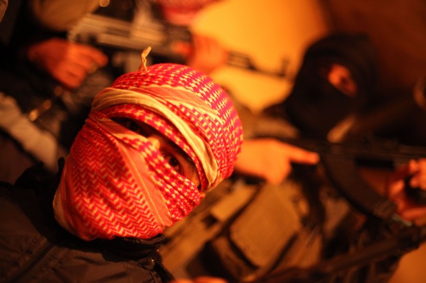 Free Syrian Army fighters, masked with Kalashnikovs
