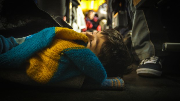 Syrian boy asleep on a bus in Serbia